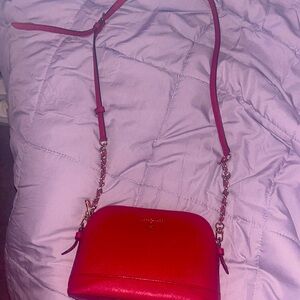 I’m selling a Micheal Joe’s croissant body purse and it is red